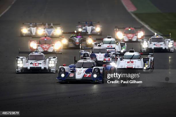 The Toyota Racing TS040 Hybrid LMP1 driven by Kazuki Nakajima of Japan, Stephane Sarrazin of France and Alexander Wurz of Austria leads the pack into...