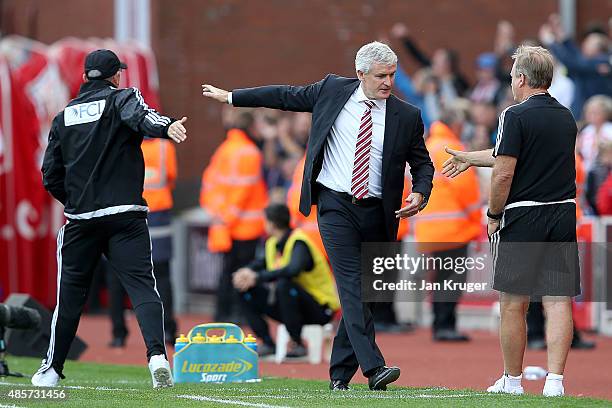 Mark Hughes manager of Stoke City and Tony Pulis manager of West Bromwich Albion leave the pitch after the Barclays Premier League match between...