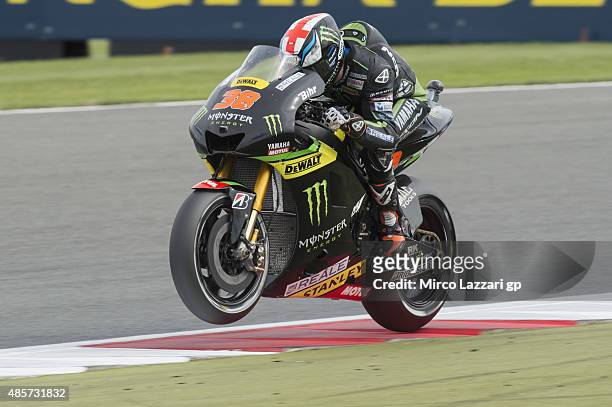 Bradley Smith of Great Britain and Monster Yamaha Tech 3 lifts the front wheel during the qualifying practice during MotoGp Of Great Britain -...