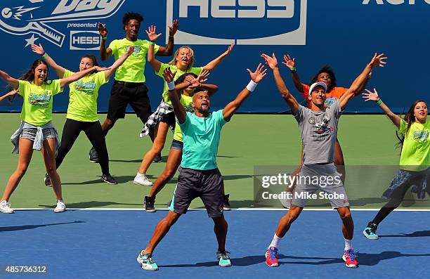 Celebrity trainer Shaun T and Novak Djokovic of Serbia take part in Arthur Ashe Kids' Day at the USTA Billie Jean King National Tennis Center on...