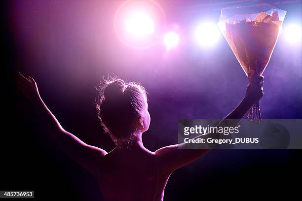 young artist girl greeting her public after performance on stage - applauding stock pictures, royalty-free photos & images