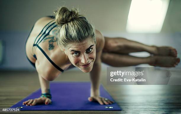 young woman exercising yoga - hot yoga stock pictures, royalty-free photos & images