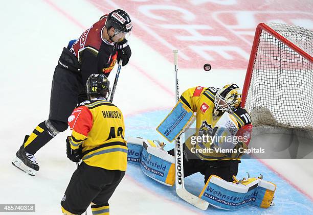 Jonathan Ferland of EV Vienna Capitals, Steve Hanusch and Thomas Duba of Krefeld Pinguine during the Champions Hockey League group stage game between...