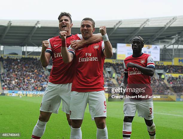 Lukas Podolski celebrates scoring the 3rd Arsenal goal with Olivier Giroud and Bacary Sagna during the Barclays Premier League match between Hull...