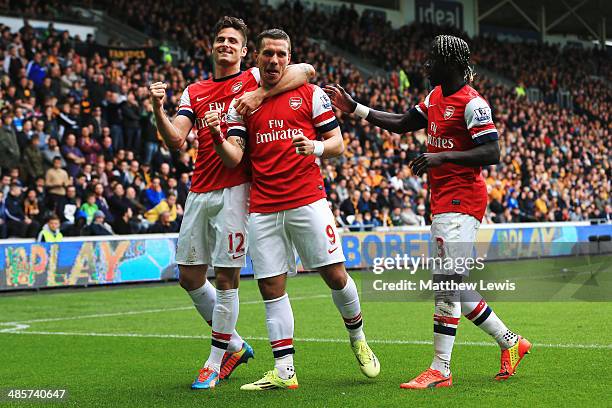 Lukas Podolski of Arsenal celebrates with team mates Olivier Giroud and Bacary Sagna after scoring his sides third goal during the Barclays Premier...