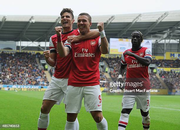 Lukas Podolski celebrates scoring the 3rd Arsenal goal with Olivier Giroud and Bacary Sagna during the Barclays Premier League match between Hull...