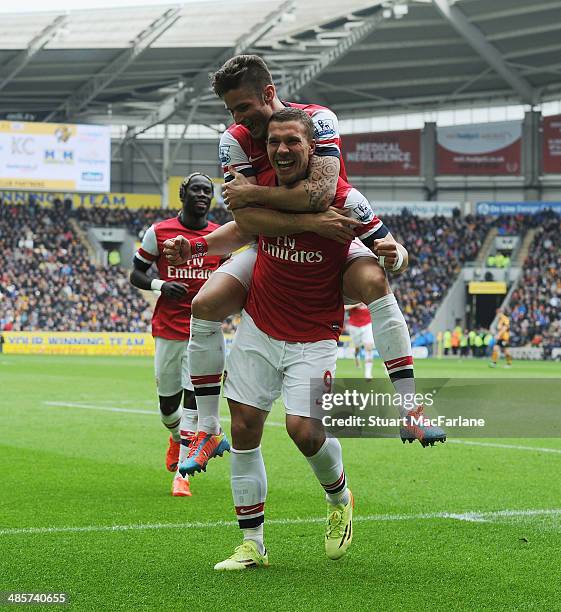 Lukas Podolski celebrates scoring the 3rd Arsenal goal with Olivier Giroud during the Barclays Premier League match between Hull City and Arsenal at...