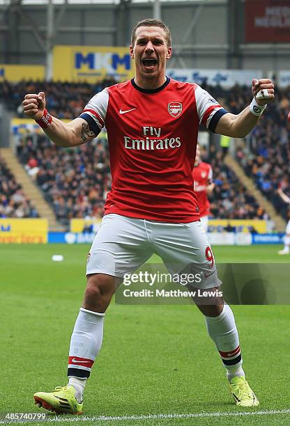 Lukas Podolski of Arsenal celebrates scoring his sides third goal during the Barclays Premier League match between Hull City and Arsenal at KC...