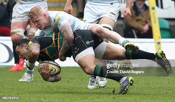 Kahn Fotuali'i of Northampton is tackled by Tom Homerduring the Aviva Premiership match between Northampton Saints and London Irish at Franklin's...