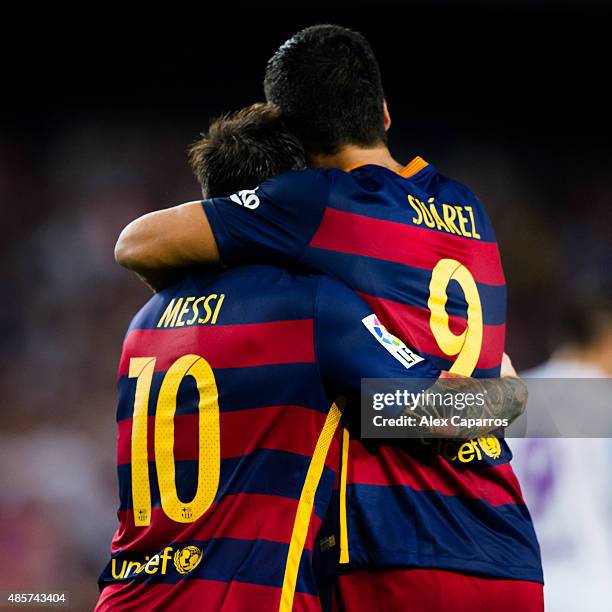 Lionel Messi and Luis Suarez of FC Barcelona celebrate after their teammate Thomas Vermaelen scored the opening goal during the La Liga match between...