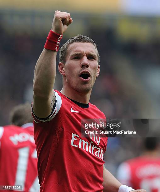 Lukas Podolski celebrates scoring the 3rd Arsenal goal during the Barclays Premier League match between Hull City and Arsenal at the KC Stadium on...