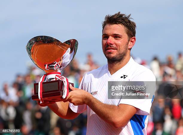 Stanislas Wawrinka of Switzerland lifts the winners trophy against Roger Federer of Switzerland in the final during day eight of the ATP Monte Carlo...