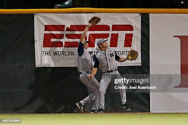 April 19: Kyle Richardson and Ryan Bull of the Notre Dame Fighting Irish miss catching the ball hit by Zack Collins of the Miami Hurricanes on April...