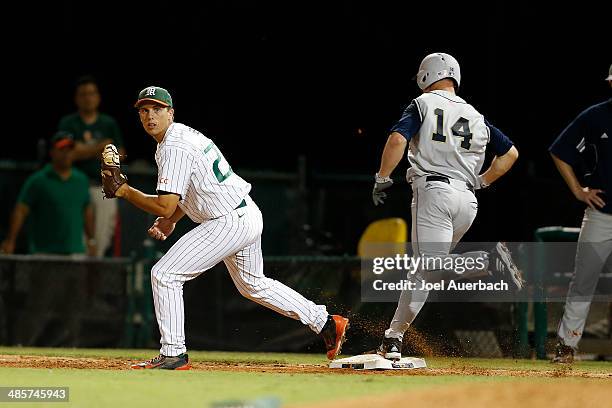 April 19: Brad Fieger of the Miami Hurricanes gets Kyle Richardson of the Notre Dame Fighting Irish out at first in the event inning on April 19,...