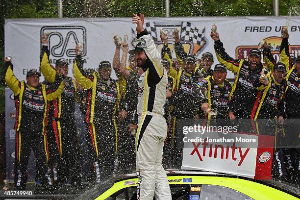 Paul Menard, driver of the Richmond/Menards Chevrolet, celebrates after taking first in the Xfinity Series Road America 180 Fired Up by Johnsonville...