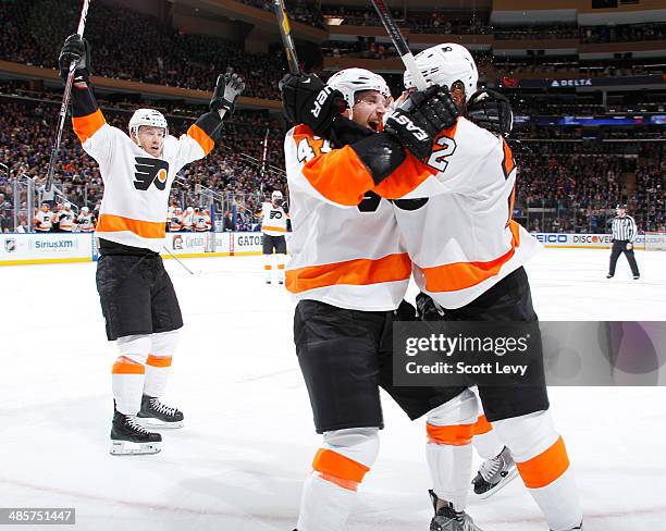 Luke Schenn, Michael Raffl and Andrew MacDonald of the Philadelphia Flyers celebrate after a second-period goal against the New York Rangers in Game...