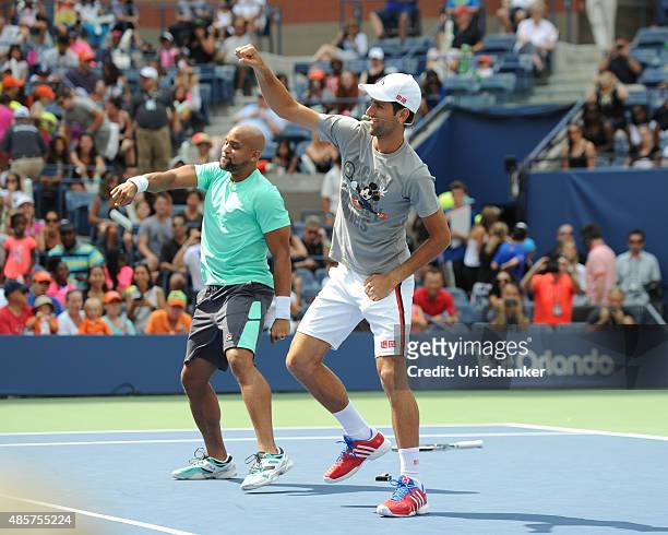 Shaun T and Novak Djokovic attend Arthur Ashe Kids Day 2015 at the US Open at USTA Billie Jean King National Tennis Center on August 29, 2015 in New...