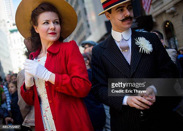 People take part in the Easter Parade and Bonnet Festival along 5th Avenue April 20, 2014 in New York City. The parade is a New York tradition dating...