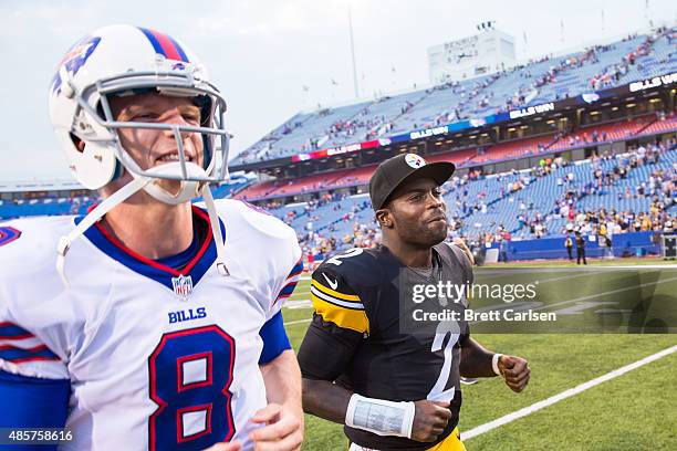 Matt Simms of the Buffalo Bills and Michael Vick of the Pittsburgh Steelers run off the field after a preseason game on August 29, 2015 at Ralph...
