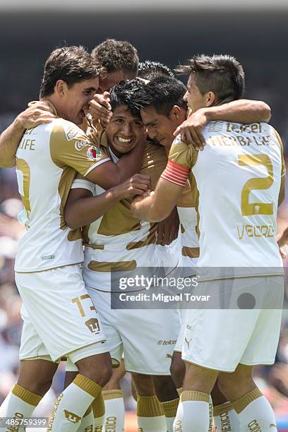 Daniel Ramirez of Pumas celebrates with his teammates after scoring the opening goal against Chivas during a match between Pumas UNAM and Chivas as...