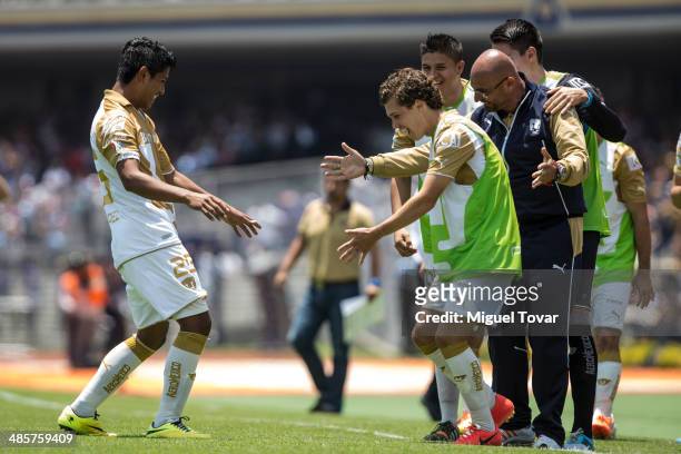Daniel Ramirez of Pumas celebrates with his teammates after scoring the opening goal against Chivas during a match between Pumas UNAM and Chivas as...