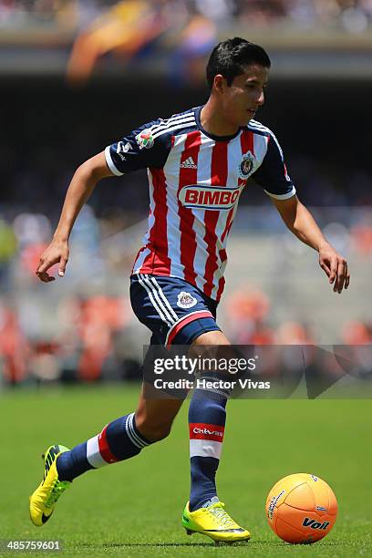 Carlos Cisneros of Chivas drives the ball during a match between Pumas UNAM and Chivas as part of the 16th round Clausura 2014 Liga MX at University...