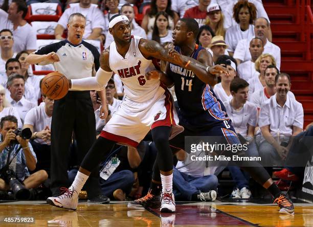 LeBron James of the Miami Heat posts up Michael Kidd-Gilchrist of the Charlotte Bobcats during Game 1 of the Eastern Conference Quarterfinals of the...