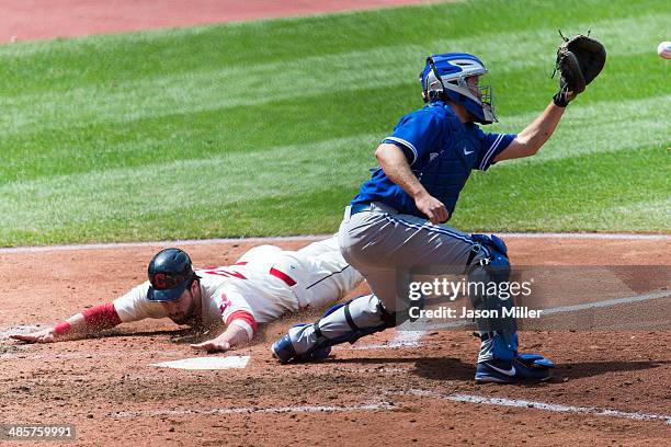 Jason Kipnis is safe at home on a double by Michael Brantley of the Cleveland Indians as catcher Josh Thole of the Toronto Blue Jays tries to make...