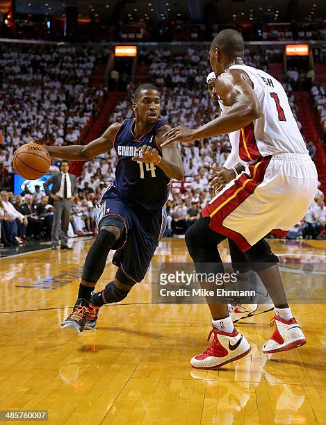 Michael Kidd-Gilchrist of the Charlotte Bobcats drives on Chris Bosh of the Miami Heat during Game 1 of the Eastern Conference Quarterfinals of the...