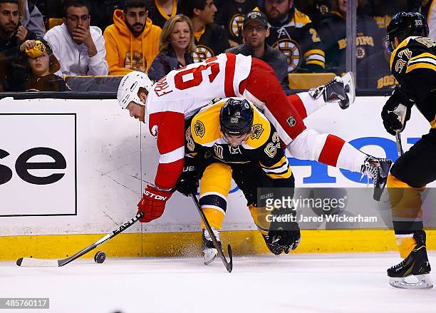 Johan Franzen of the Detroit Red Wings flips over Brad Marchand of the Boston Bruins in the first period during the game at TD Garden on April 20,...