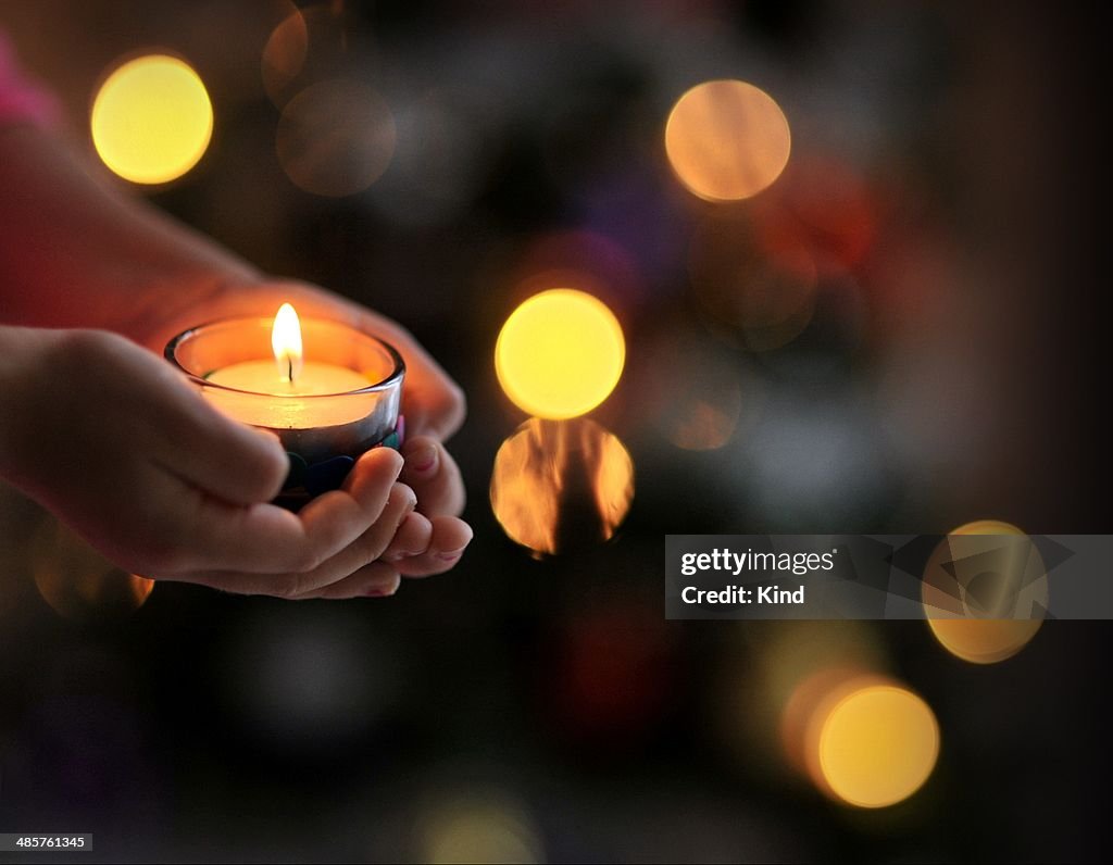 Candle in hands