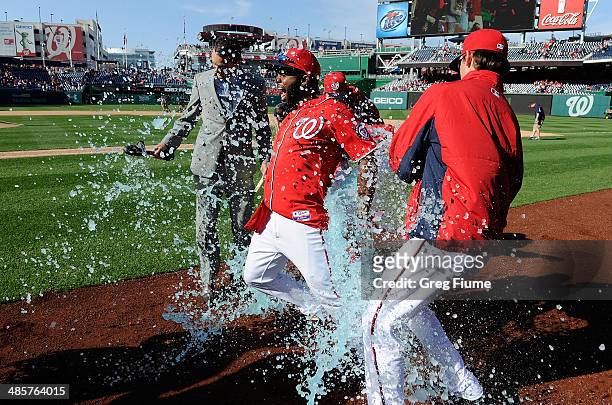 Denard Span of the Washington Nationals is doused with Gatorade by Drew Storen and Tyler Clippard after driving in the game winning run in the ninth...