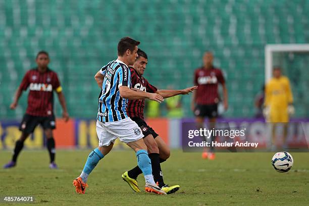 Paulinho Dias of Atletico-PR competes for the ball with Ramiro of Gremio during the match between Atletico-PR and Gremio for the Brazilian Series A...