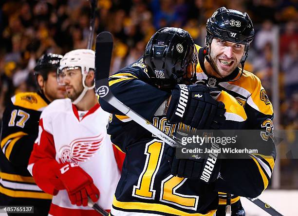 Zdeno Chara of the Boston Bruins celebrates his goal with teammate Jarome Iginla in the third period against the Detroit Red Wings during the game at...