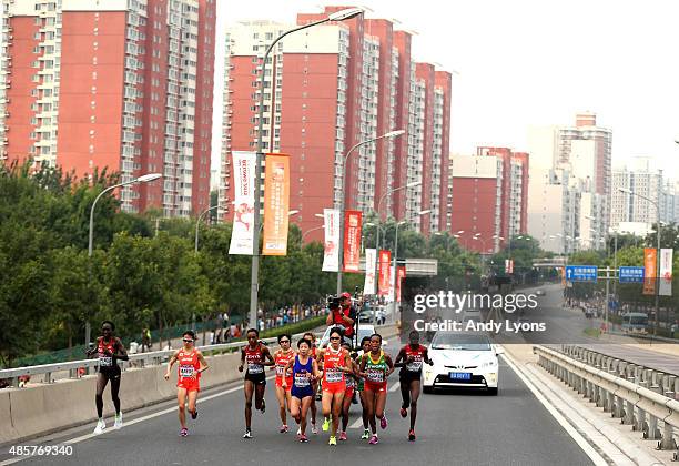 Risa Shigetomo of Japan, Hye-Song Kim of North Korea and Tirfi Tsegaye of Ethiopia lead the field during the Women's Marathon on day nine of the 15th...