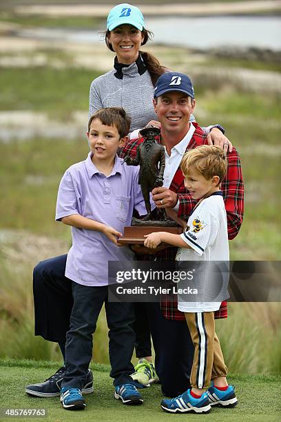 Matt Kuchar poses with his family Cameraon, wife Sybi, and Carson on the 18th green after winning the RBC Heritage at Harbour Town Golf Links on...