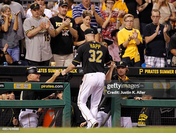 Happ of the Pittsburgh Pirates is congratulated by fans and teammates after leaving the game in the sixth inning during the game against the Colorado...