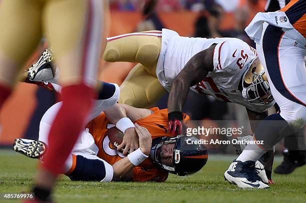 Peyton Manning of the Denver Broncos is sacked by NaVorro Bowman of the San Francisco 49ers during the first half of action at Sports Authority Field...