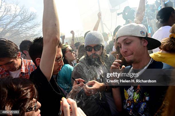 Hundreds of people lit up joints, bongs, pipes and marijuana cigarettes at exactly 4:20 pm during the Colorado 420 Rally at Civic Center Park in...