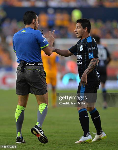 Danilo Veron of Queretaro argues with referee Roberto Rios during a 7th round match between Tigres UANL and Queretaro as part of the Apertura 2015...