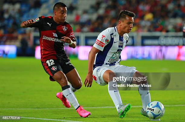 Osvaldo Rodriguez of Pachuca struggles for the ball with Rodolfo Vilchis of Atlas during a 7th round match between Pachuca and Atlas as part of the...