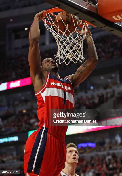 Trevor Ariza of the Washington Wizards dunks over Mike Dunleavy of the Chicago Bulls in Game One of the Eastern Conference Quarterfinals during the...