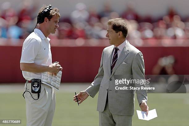 Head coach Nick Saban of the Alabama Crimson Tide speaks with offensive coordinator Lane Kiffin during the Alabama A-Day spring game at Bryant-Denny...