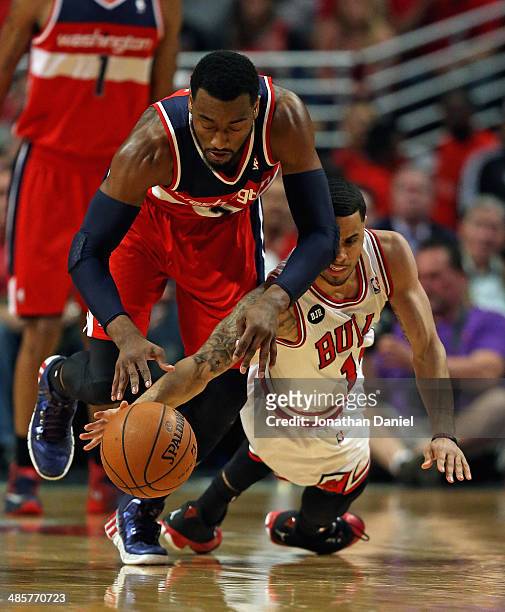 John Wall of the Washington Wizards battles for the ball with D.J. Augustin of the Chicago Bulls in Game One of the Eastern Conference Quarterfinals...
