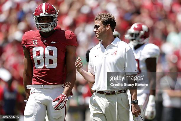 Offensive coordinator Lane Kiffin of the Alabama Crimson Tide speaks with O.J. Howard of the Crimson team during the University of Alabama A-Day...