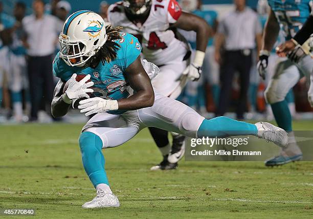 Jay Ajayi of the Miami Dolphins rushes during a preseason game against the Atlanta Falcons at Sun Life Stadium on August 29, 2015 in Miami Gardens,...