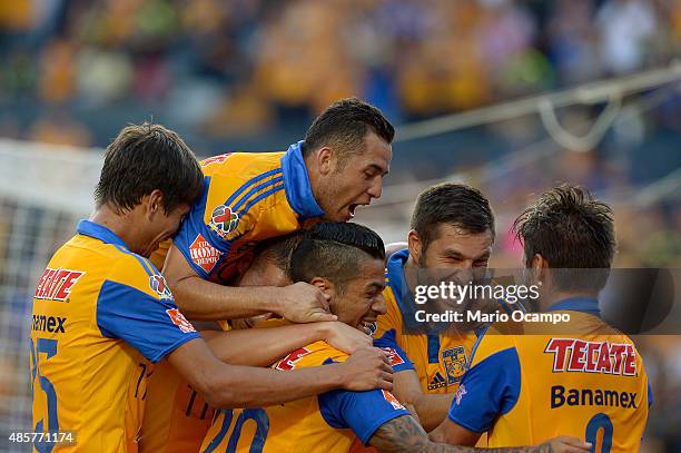Rafael Sobis of Tigres celebrates with teammates after scoring his team's fourth goal during a 7th round match between Tigres UANL and Queretaro as...