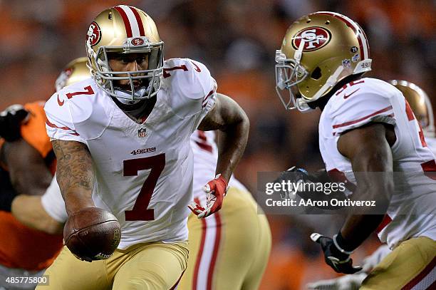 Colin Kaepernick of the San Francisco 49ers hands off to Kendall Hunter against the Denver Broncos during the first half of action at Sports...