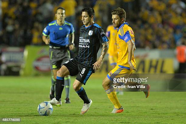 Rafael Sobis of Tigres fights for the ball with Danilo Veron of Queretaro during a 7th round match between Tigres UANL and Queretaro as part of the...