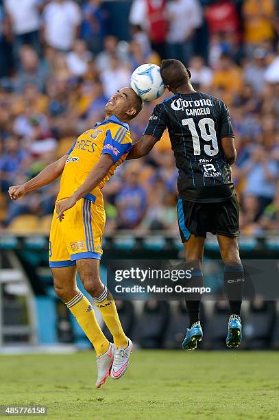 Guido Pizarro of Tigres fights to head the ball with Yerson Candelo of Queretaro during a 7th round match between Tigres UANL and Queretaro as part...